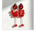 Teardrop-shaped gemstone earrings with multi-layered crystal beads and long tassel design