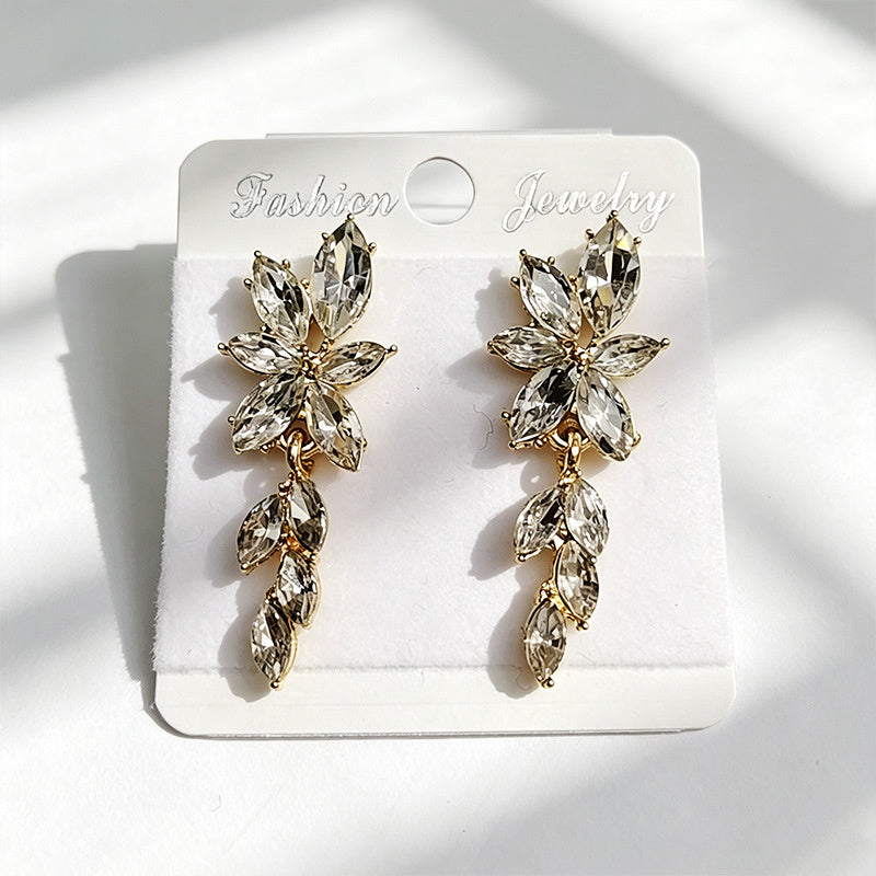 Gilt and diamond-encrusted floral earrings, long earrings for a French elegant style photo shoot or date