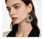 Irish-style woven pattern hollow earrings with distressed silver hoops and green jade beads, versatile for casual vacations