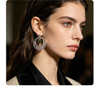 Irish-style woven pattern hollow earrings with distressed silver hoops and green jade beads, versatile for casual vacations
